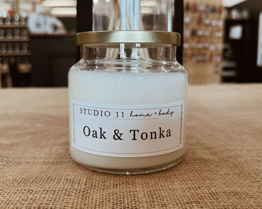 Handcrafted oak and tonka room soy candle from Studio 11 Home and Body in Huntsville AL, featuring warm woody notes