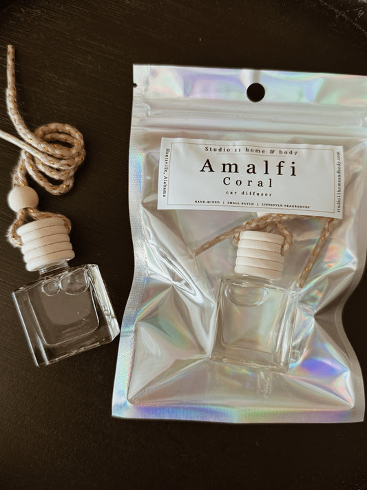 Crafted with a clean, non-toxic fragrance base, this hanging car diffuser releases a soft, continuous scent that lingers gently and enhances your space with quiet sophistication. The minimalist glass vessel is finished with a natural wooden twist cap that absorbs and diffuses fragrance over time, while the adjustable rope allows you to style it to your desired length.

If you’re searching for a luxury car diffuser, a clean car air freshener, or a deep, masculine-leaning coastal scent that actually lasts, Am