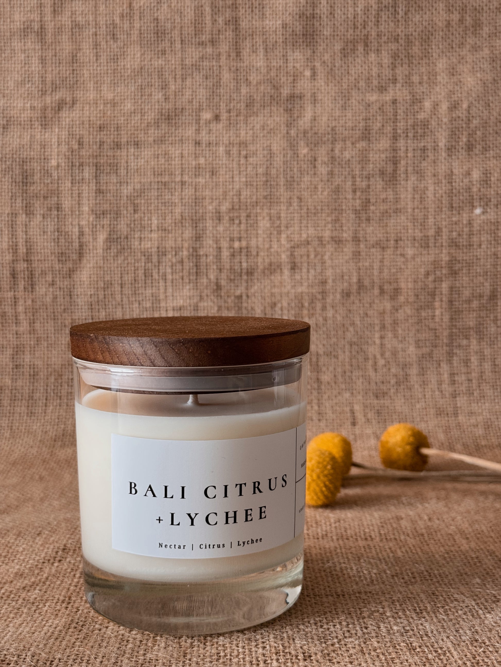 Bright citrus zest and lush tropical fruit open this vibrant fragrance, unfolding into juicy lychee nectar and sun-ripened mango with a soft, radiant sweetness. Bali Citrus + Lychee is luminous, fresh, and effortlessly luxurious—like warm island air drifting through a market of freshly sliced citrus and exotic fruit.