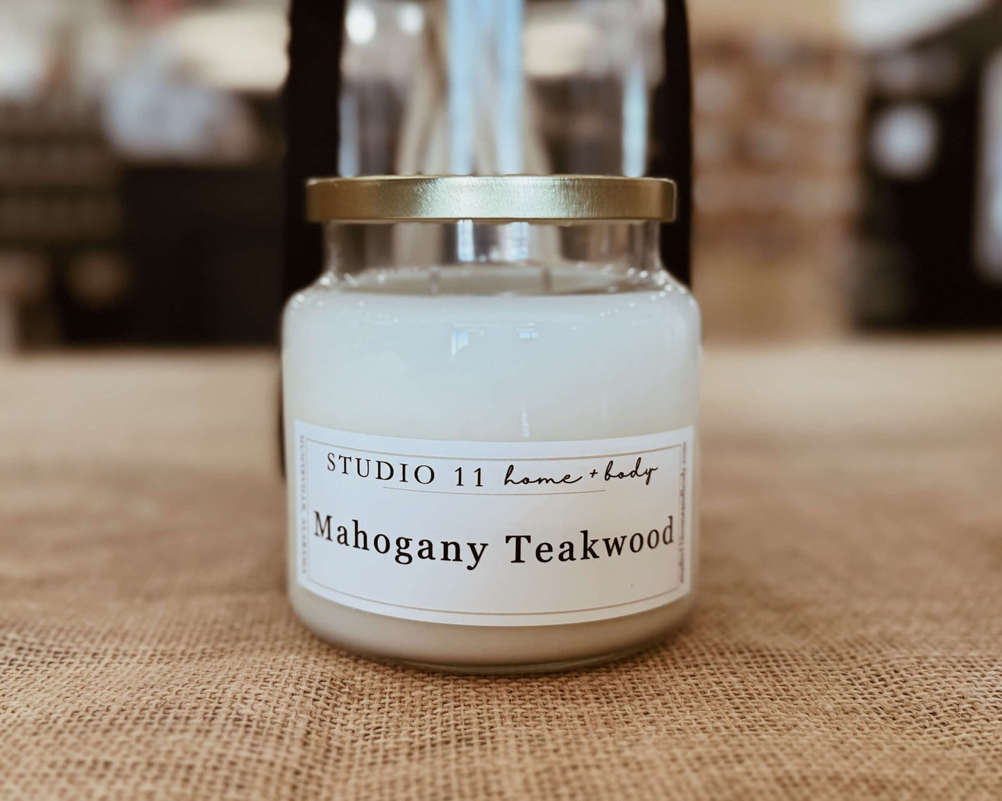 Premium soy candle with mahogany and teakwood notes, handcrafted at Studio 11 Home and Body in Huntsville AL