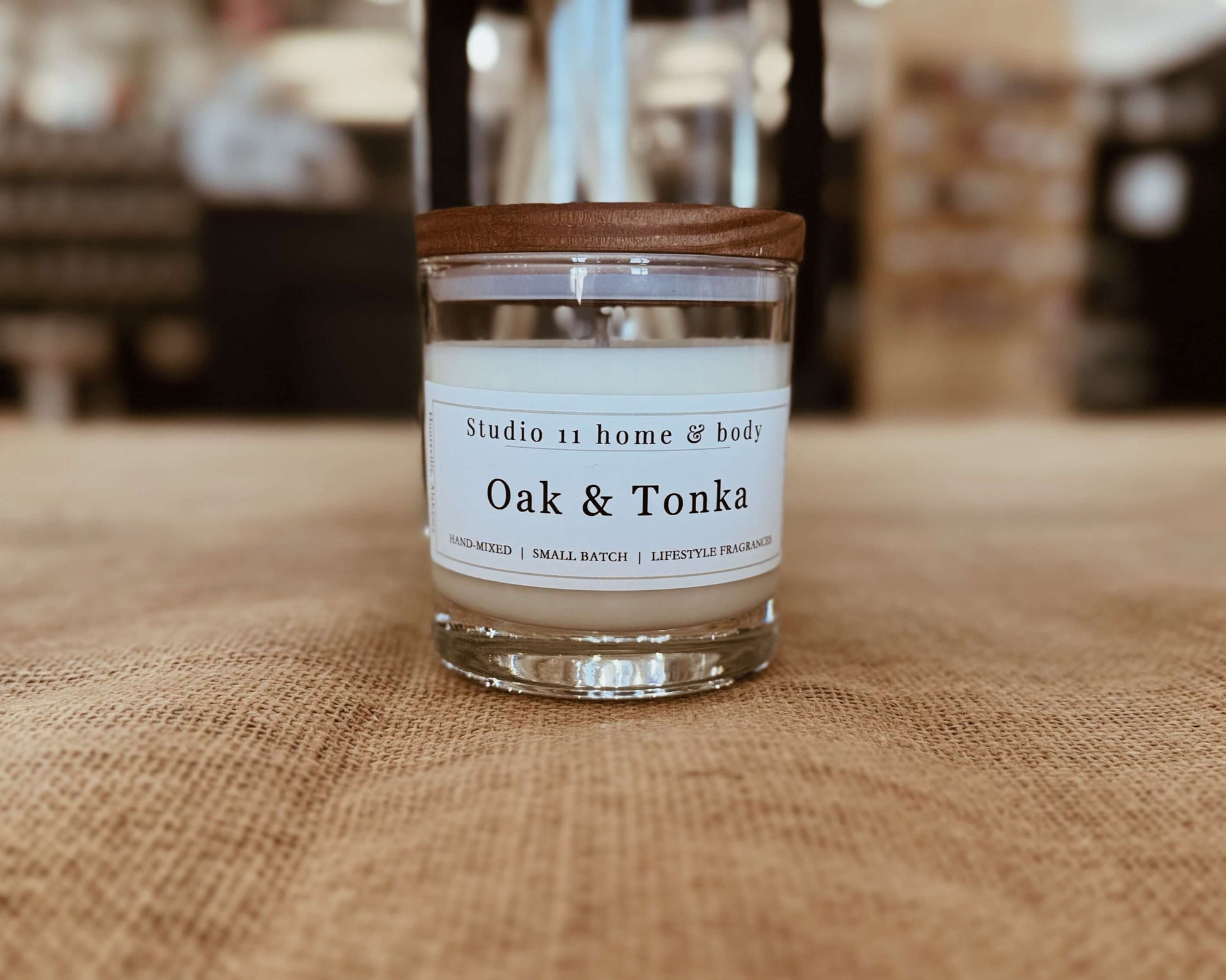 Handcrafted oak and tonka room small soy candle from Studio 11 Home and Body in Huntsville AL, featuring warm woody notes